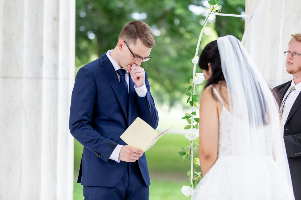 Groom wiping away tears during an intimate DC War Memorial elopement ceremony