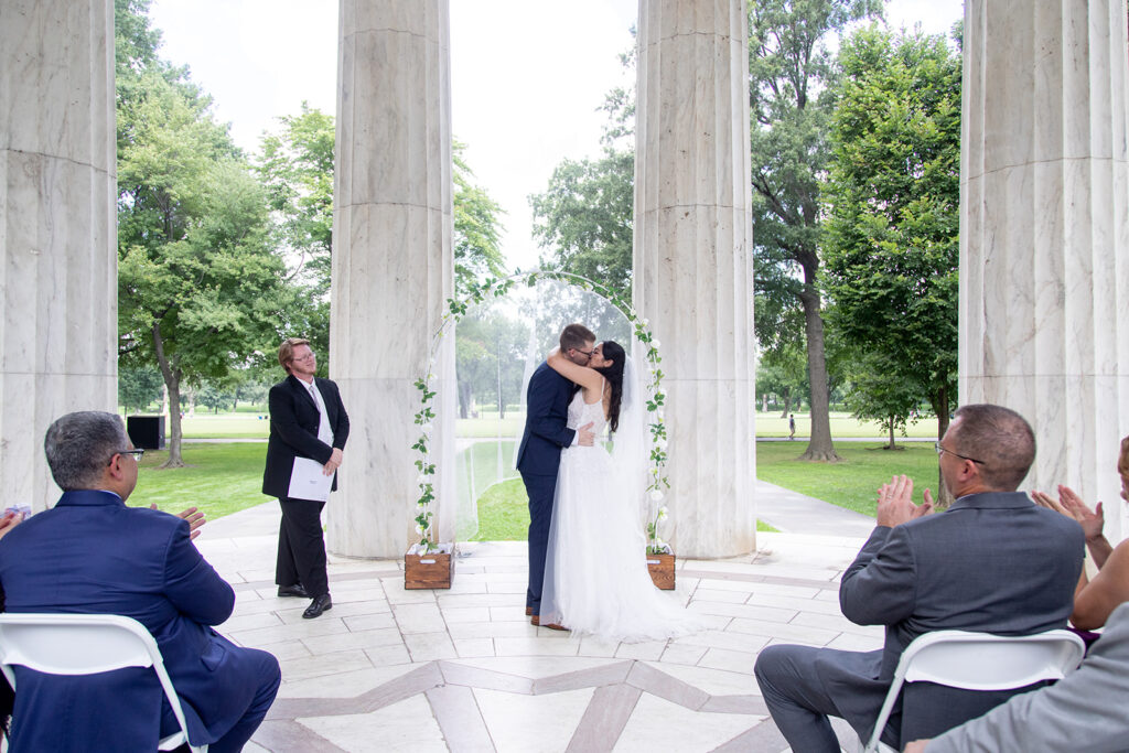 Intimate elopement ceremony at the DC War Memorial with guests seated during vows