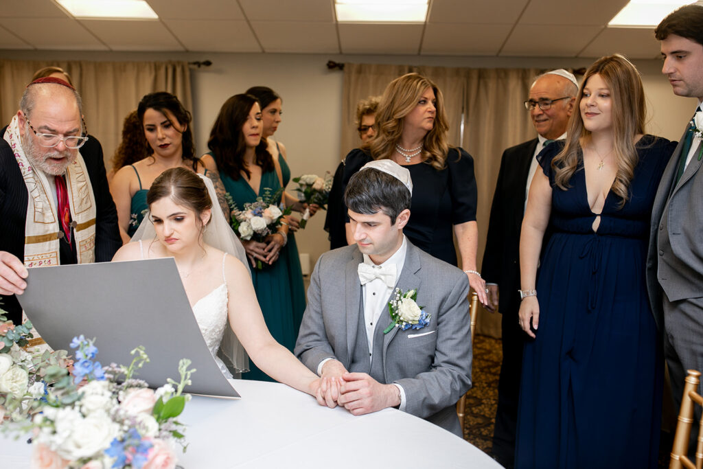 Intimate Jewish ketubah signing before ceremony at The Woodlands at Algonkian