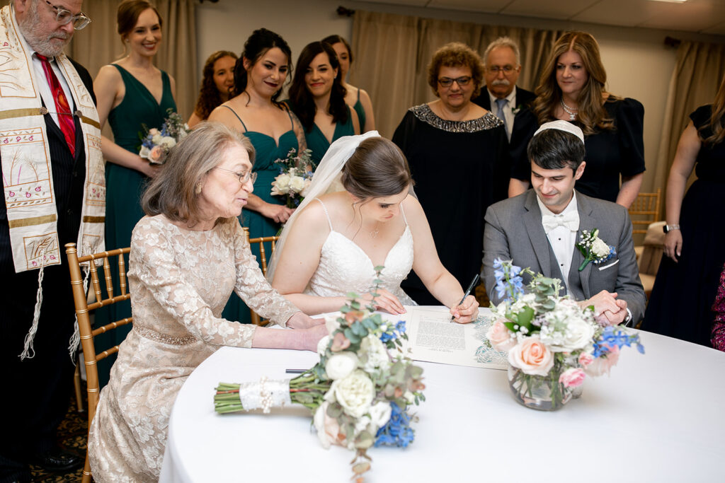 Intimate Jewish ketubah signing before ceremony at The Woodlands at Algonkian