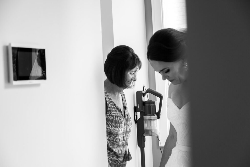 Bride sharing a tender moment with a loved one while getting ready for her intimate Alexandria wedding.