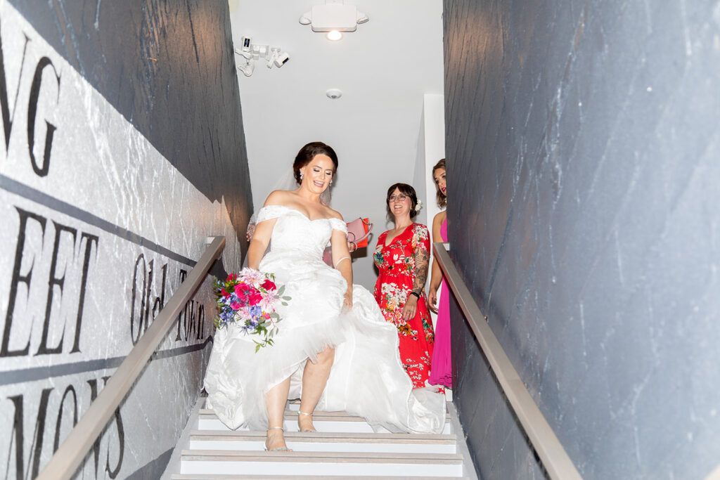 Bride walking down the stairs on her way to a first look during an intimate wedding in Alexandria, Virginia.