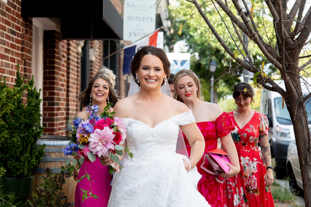 Bride walking through Old Town Alexandria with close friends on the way to her first look during an intimate wedding.