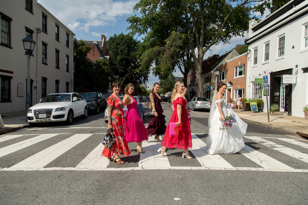 Bride and wedding party crossing the street in Old Town Alexandria during an intimate wedding day.