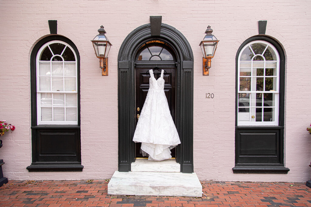 Wedding dress hanging outside a historic building in downtown Alexandria before Jodi and Stu’s intimate wedding.