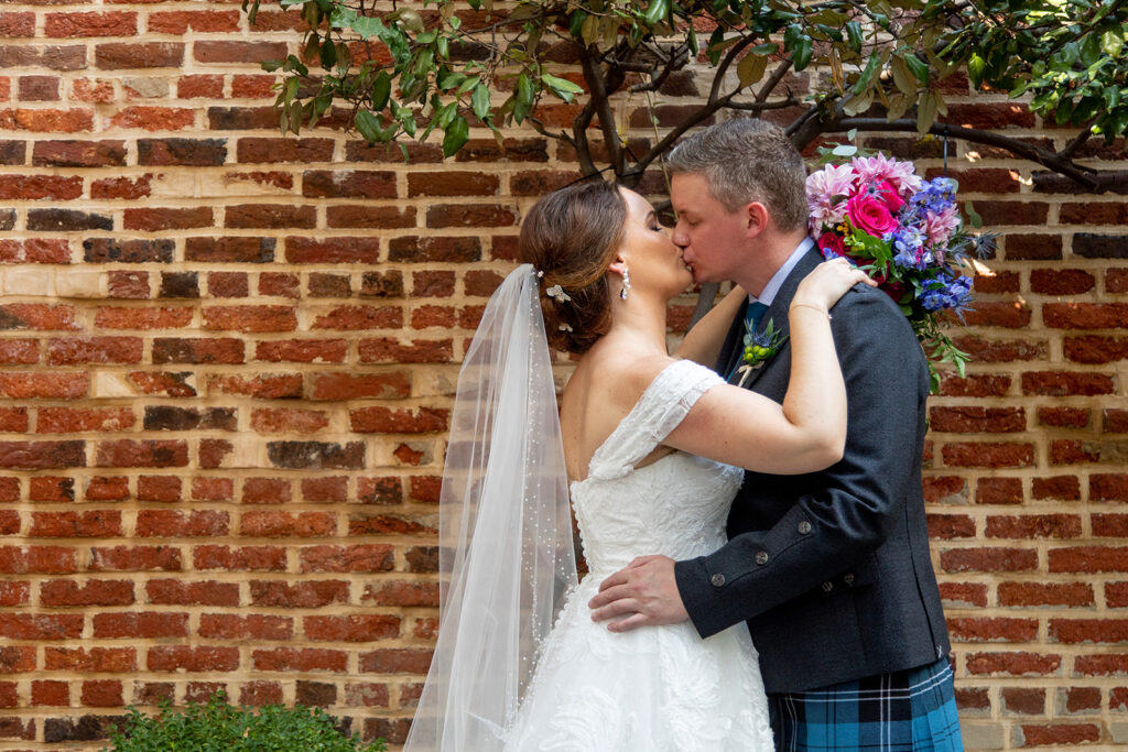 Bride and groom sharing a kiss during their first look at an intimate Alexandria wedding.