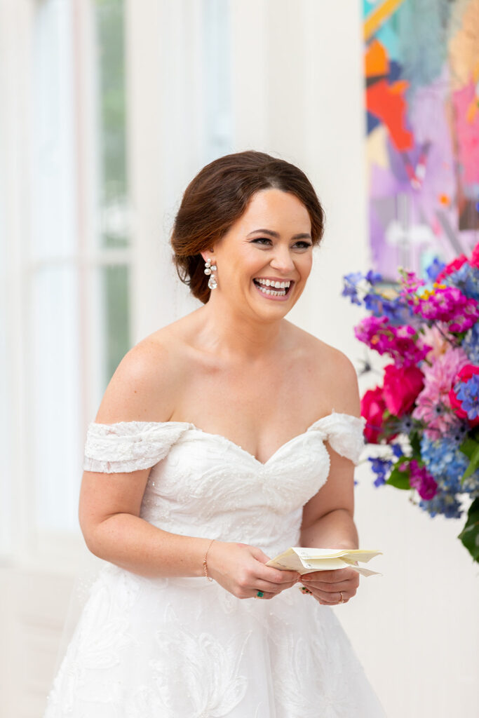 Bride smiling while reading her vows during an intimate wedding ceremony in Alexandria.