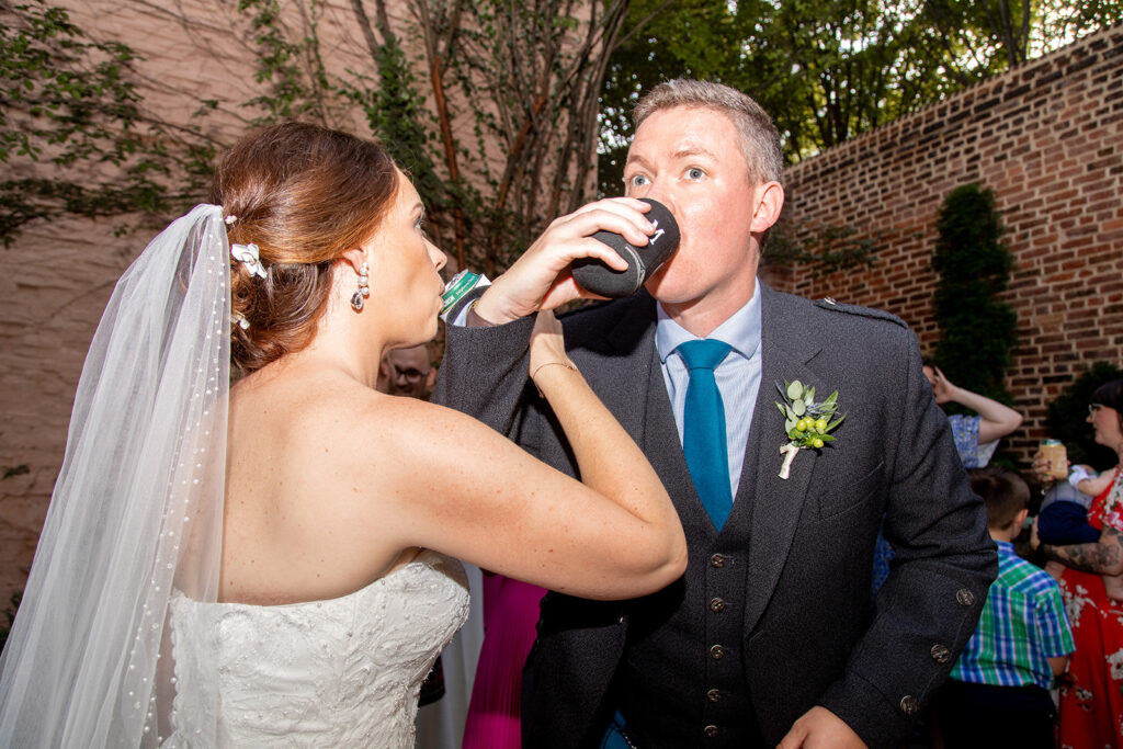 Bride and groom sharing a toast during cocktail hour at the Athenaeum in Alexandria.
