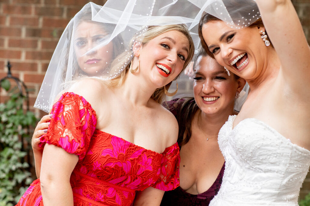 Bride taking a selfie with friends during cocktail hour at the Athenaeum in Alexandria.