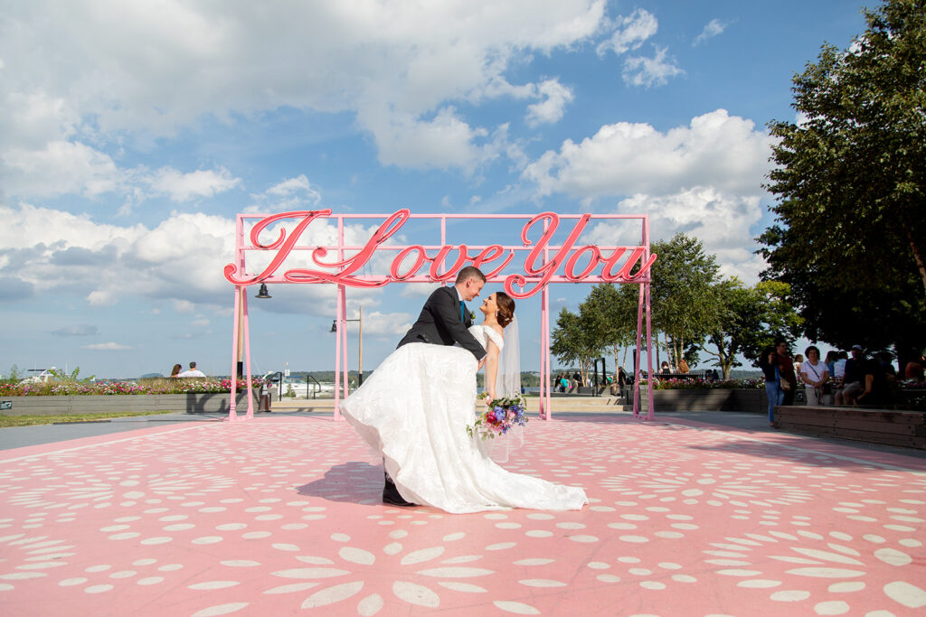 Bride and groom posing near the Alexandria waterfront during downtown Alexandria wedding portraits.