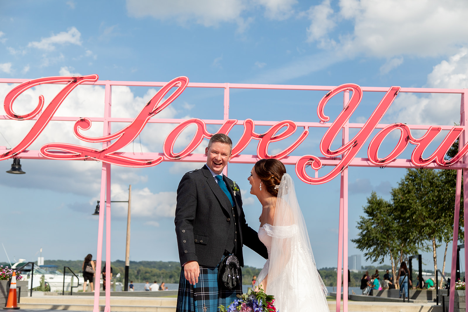 Bride and groom sharing a kiss during downtown Alexandria wedding portraits near the waterfront.