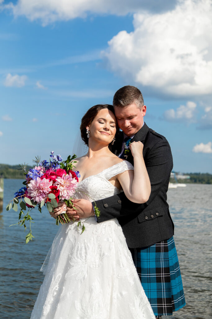 Bride and groom standing close together during downtown Alexandria waterfront wedding portraits.