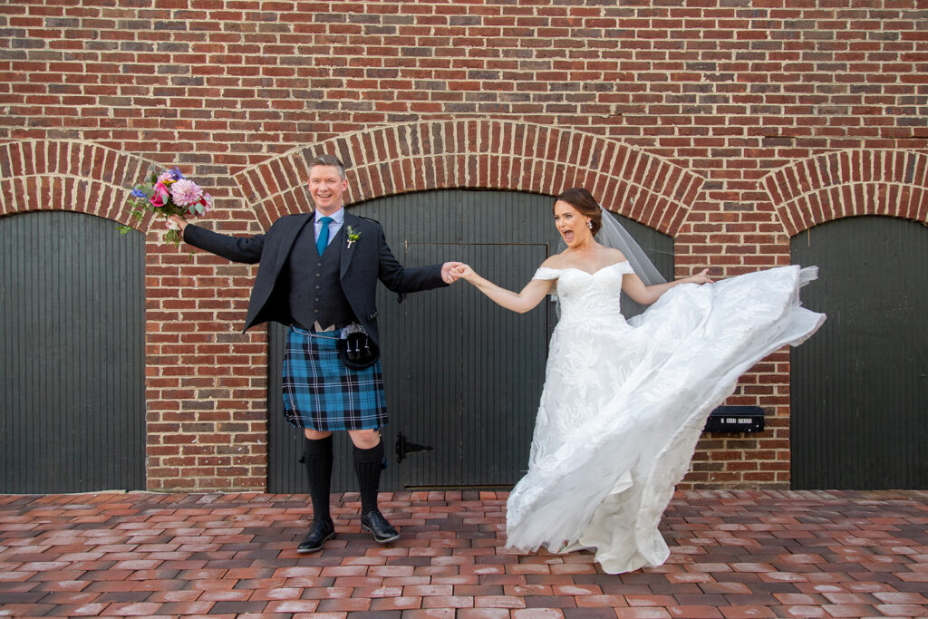 Bride and groom spinning together during downtown Alexandria wedding portraits.