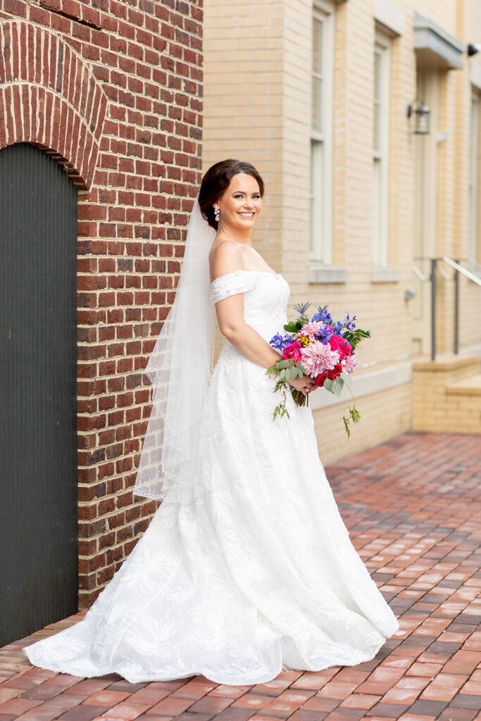 Bride holding a colorful bouquet during downtown Alexandria wedding portraits.