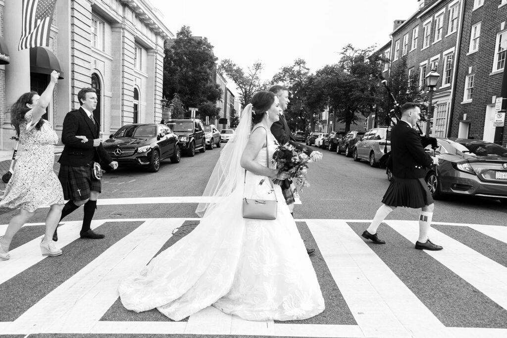 Bride walking through a downtown Alexandria crosswalk during a wedding processional.