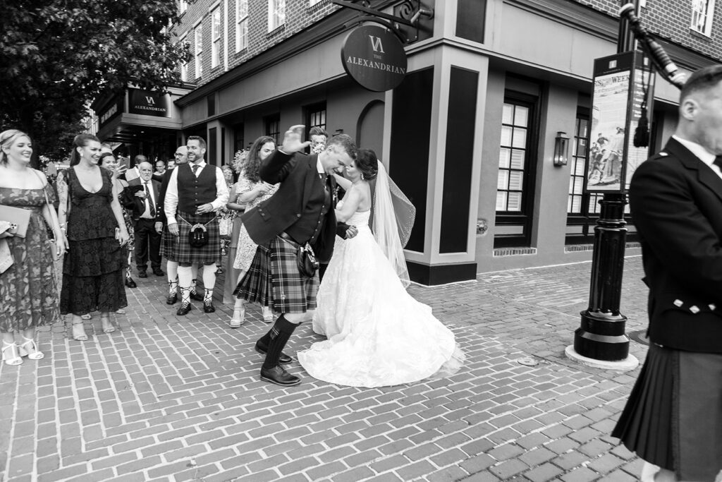 Bride and groom dancing in the street during a downtown Alexandria wedding processional.