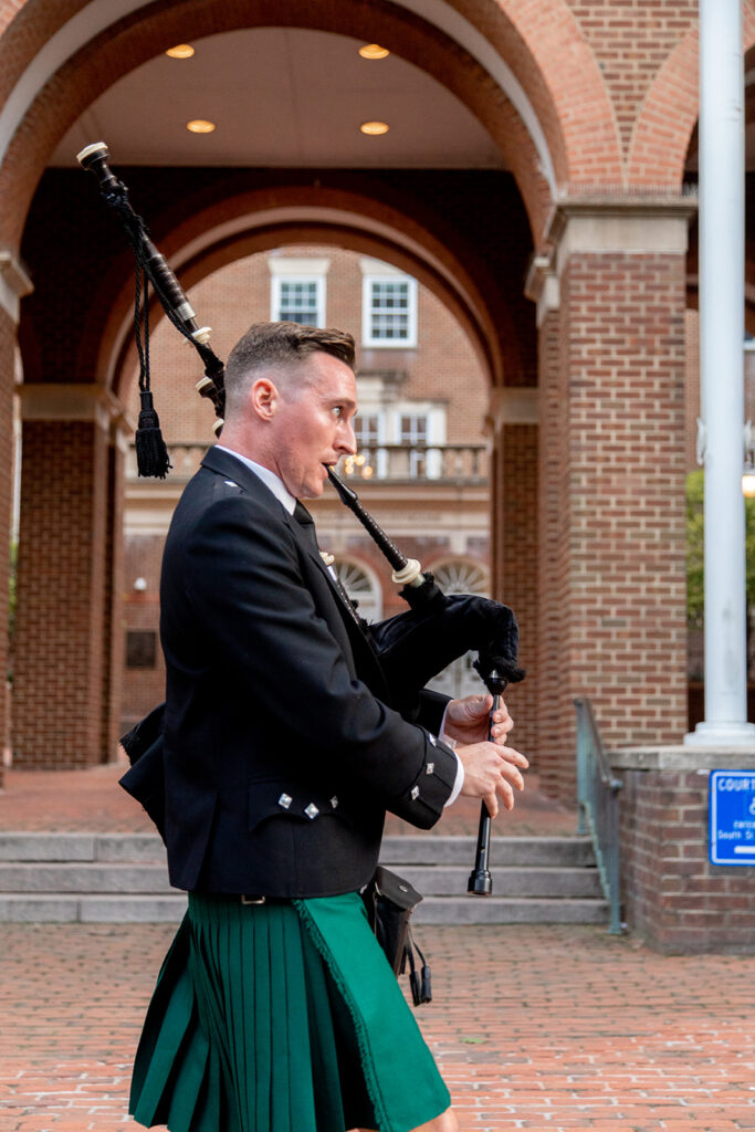 Musician leading a wedding processional through downtown Alexandria.