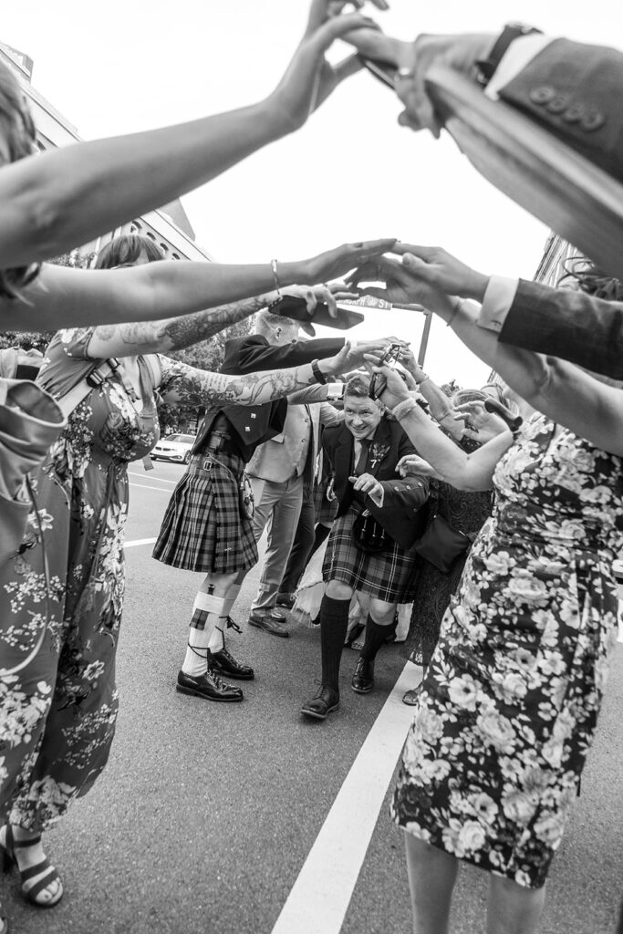 Wedding guests forming an arch during a downtown Alexandria wedding processional.