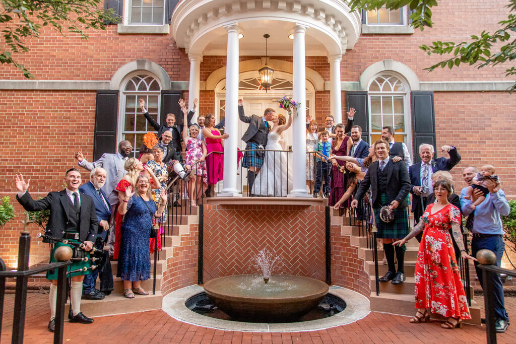 Bride and groom celebrating with guests during their wedding reception at the Morrison House in Alexandria.