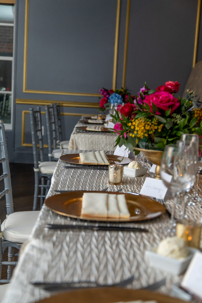 Wedding reception place setting with florals at the Morrison House in Alexandria.