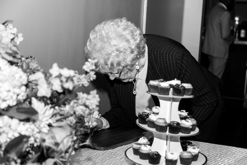 Grandmother of the bride writes in the guest book at intimate wedding located in downtown Alexandira