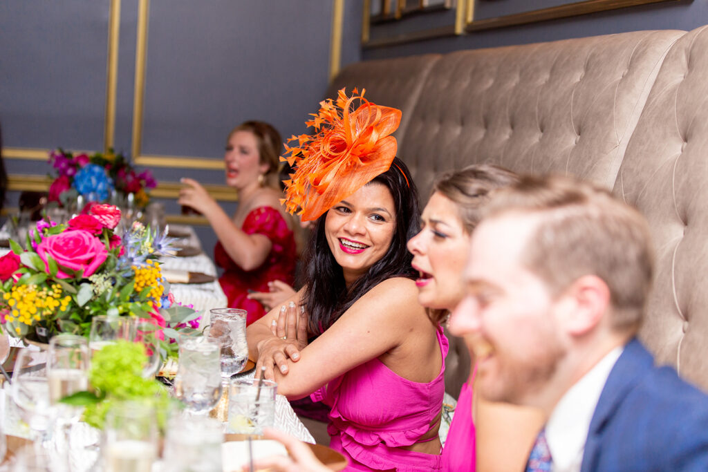 Wedding guests laughing together during dinner at the Morrison House wedding reception in Alexandria.