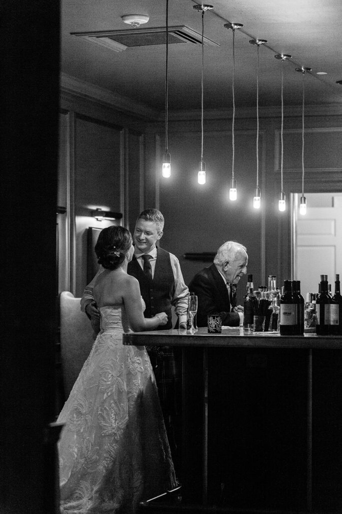Bride and groom sharing a quiet moment at the bar during their Morrison House wedding reception in Alexandria.