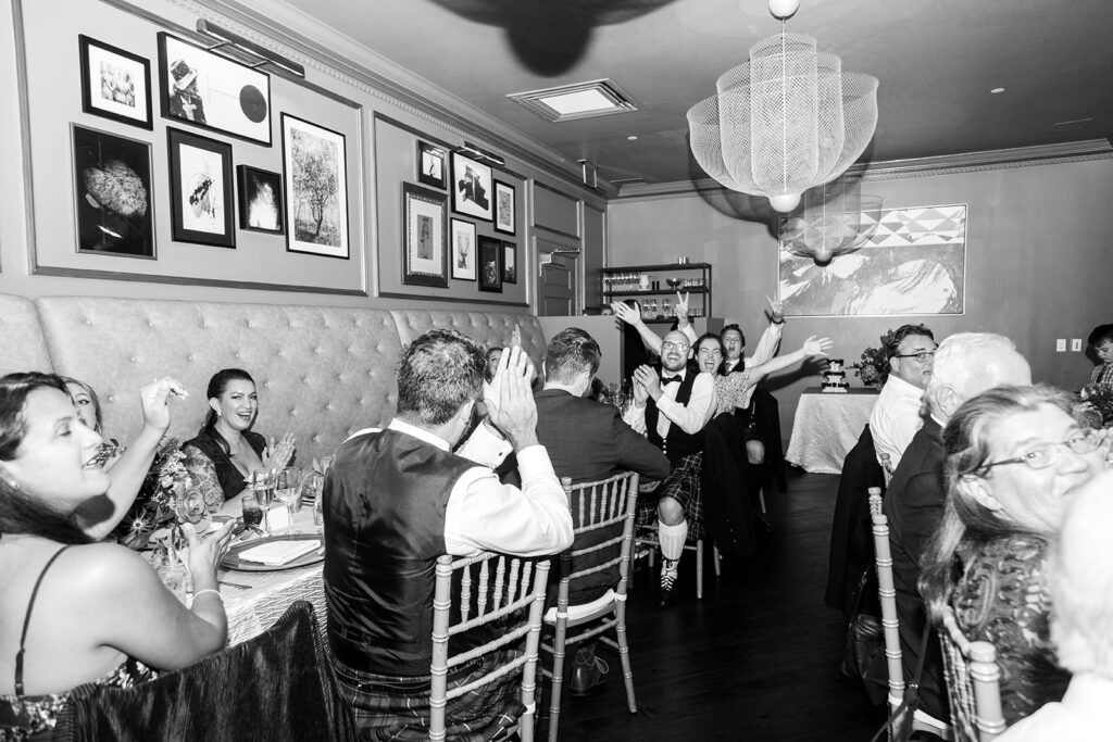 Wedding guests applauding during a reception at the Morrison House in Alexandria.
