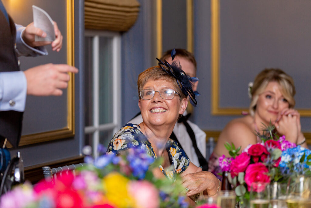 Wedding guest smiling during an intimate reception at the Morrison House in Alexandria.