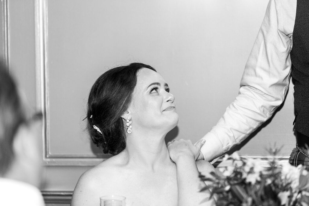 Bride listening emotionally during a wedding toast at the Morrison House in Alexandria.