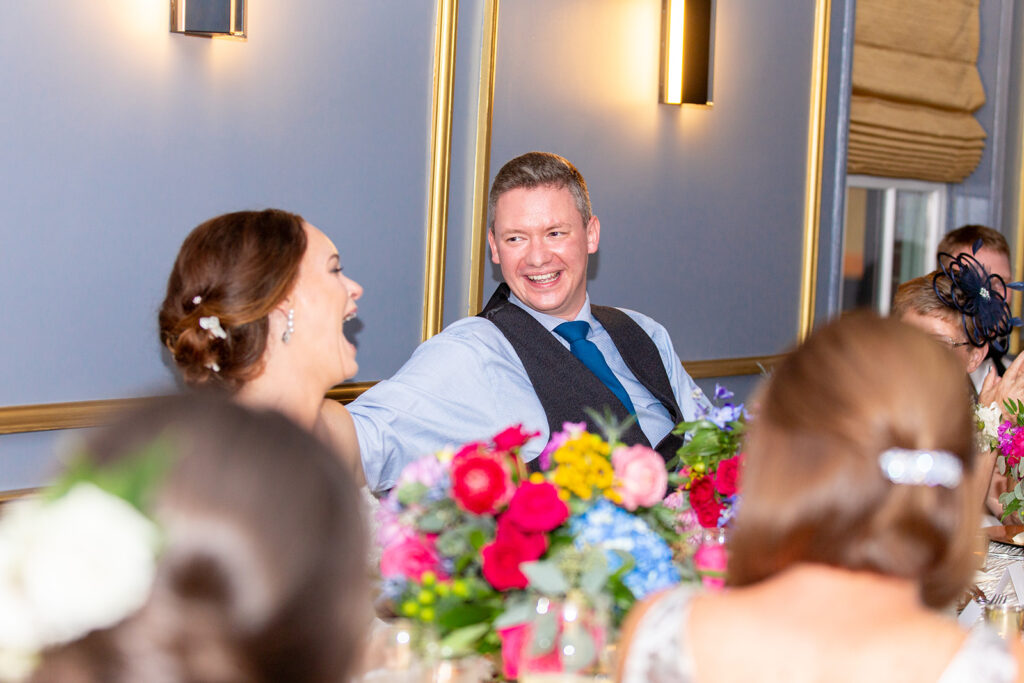 Groom laughing with guests during the Morrison House wedding reception in Alexandria.