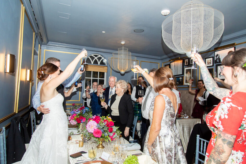 Wedding guests cheering during an intimate reception at the Morrison House in Alexandria.