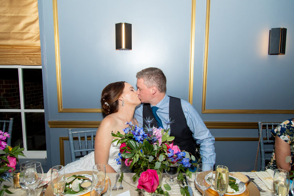Bride and groom sharing a kiss during their Morrison House wedding reception in Alexandria.