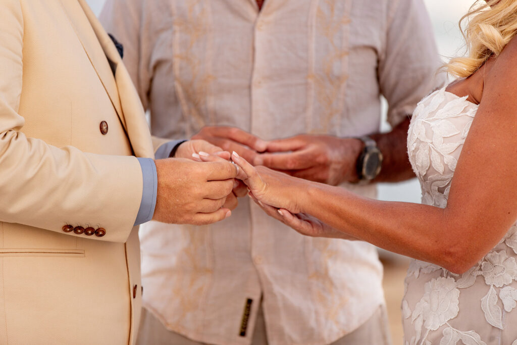 Ring exchange during intimate destination wedding ceremony in Cancun, Mexico