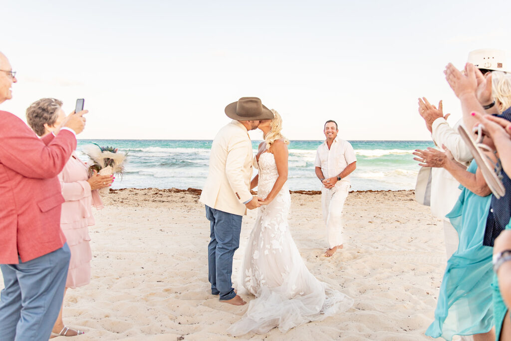 First kiss during luxury beach wedding at Le Blanc Cancun