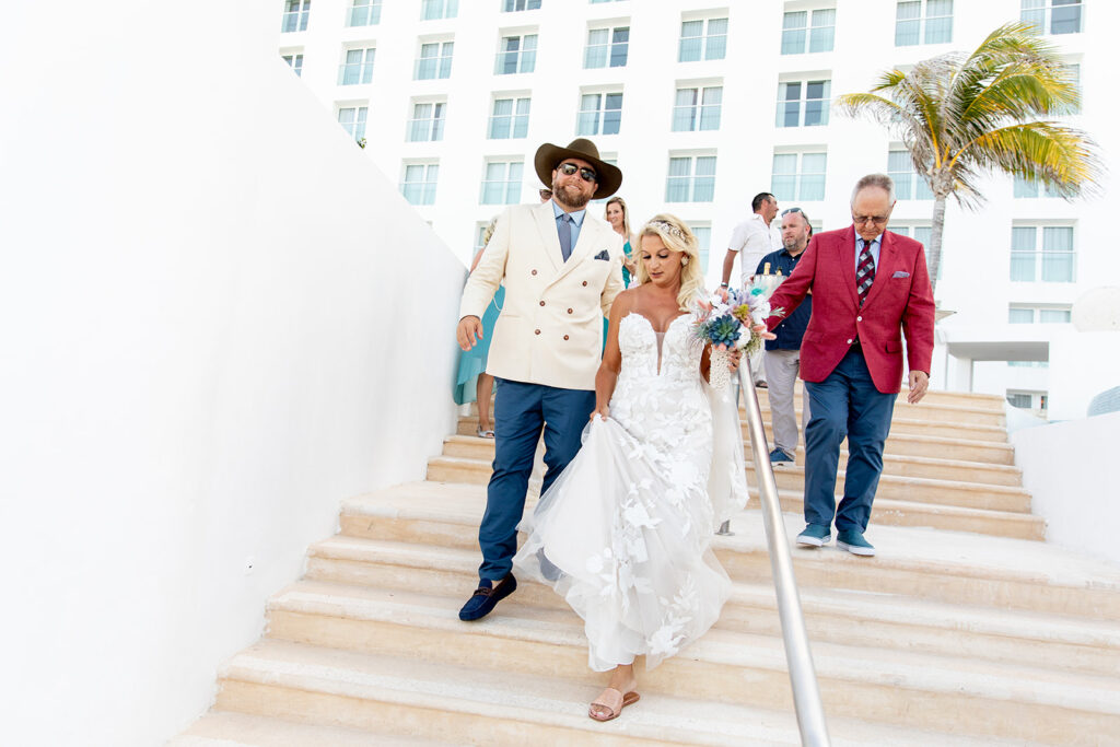 Bride and groom walking to beach ceremony at Le Blanc Cancun destination wedding