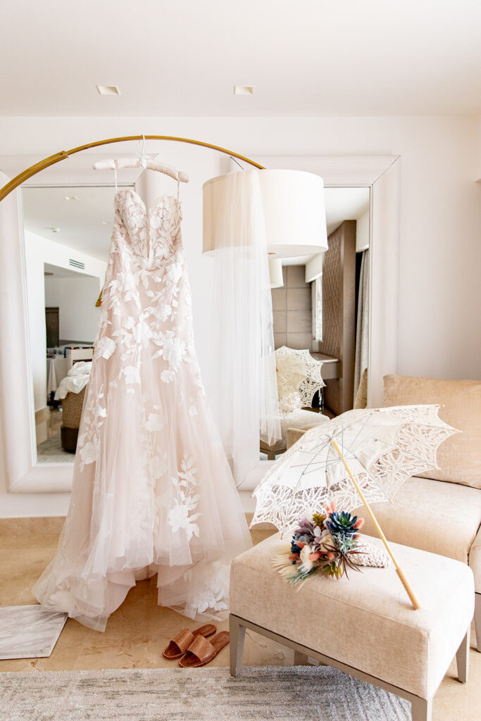 Bride’s wedding dress hanging in luxury suite at Le Blanc Spa Resort Cancun