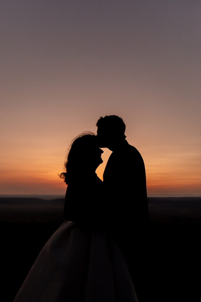 Silhouette of Phillip and Reanna at sunset during a post-wedding session in Shenandoah National Park
