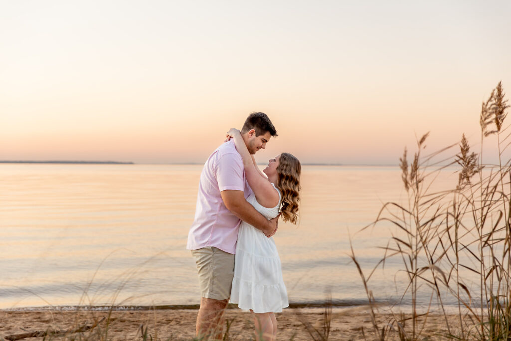 Romantic coastal engagement photos near DC with a couple embracing at Terrapin Nature Park